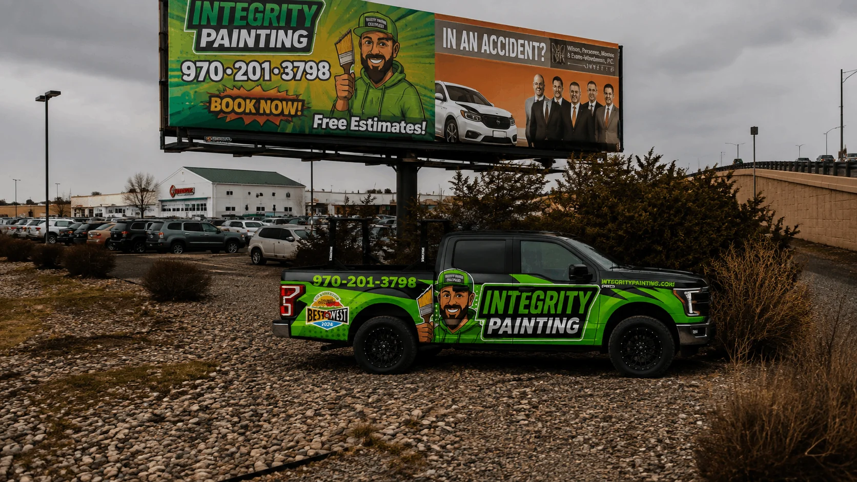 Integrity Painting billboard advertising free estimates with the company truck parked below it in Grand Junction