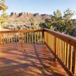 Freshly stained wooden deck with railing overlooking the Book Cliffs in Grand Junction, Colorado