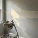 Drywall seam and patch filled with joint compound and sanded smooth before painting