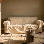Painter cutting in a crisp line where the wall meets white trim during an interior painting job in Grand Junction CO